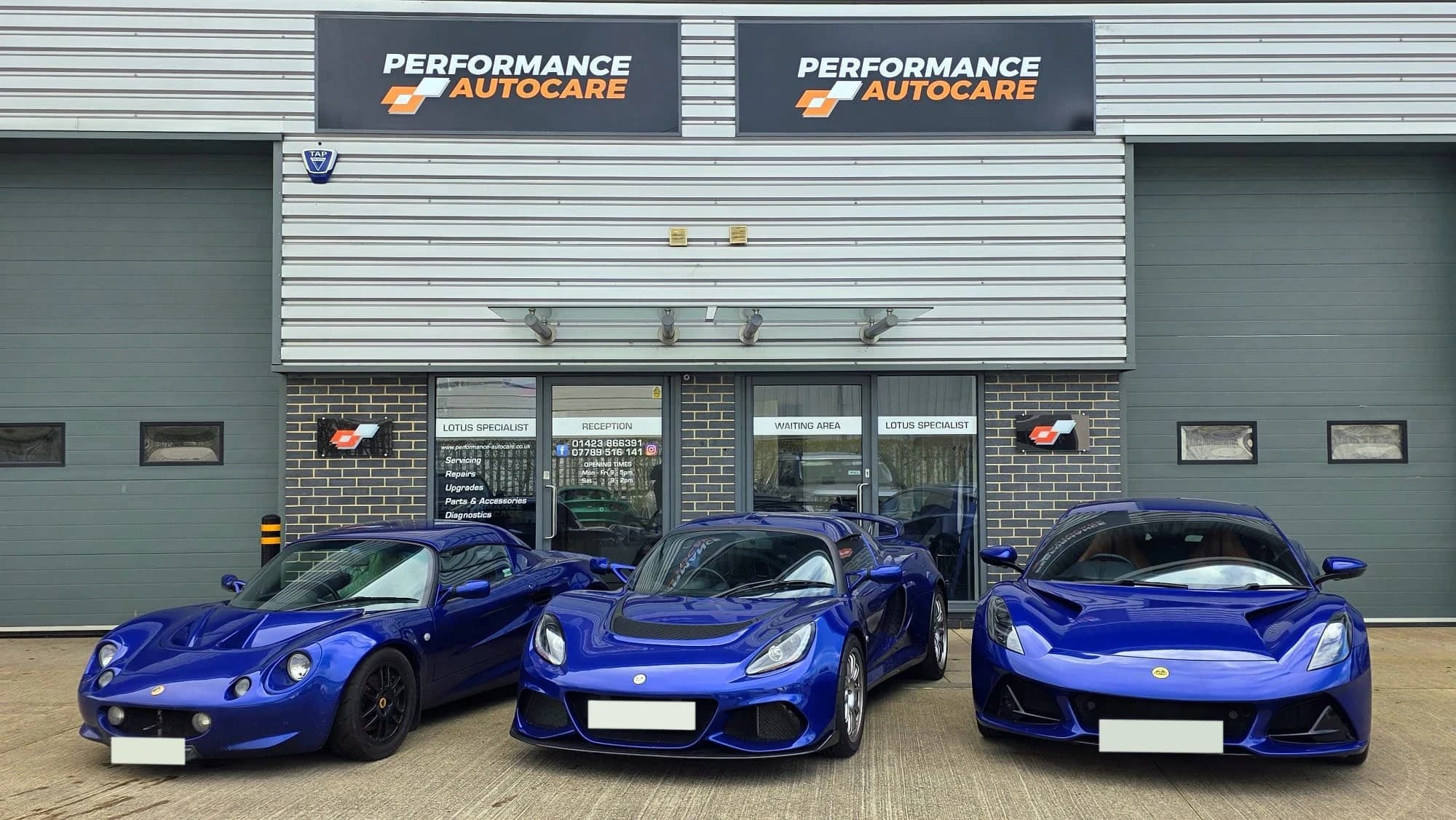 Three blue Lotus outside the Performance Autocare workshop