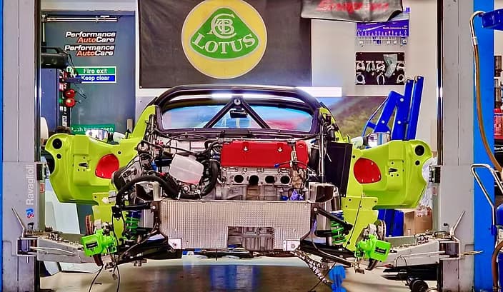 Stripped down green Exige in Performance Autocare Workshop